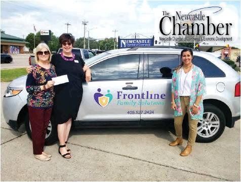 Todd Newville/The Newcastle Pacer                                Gayla Riddle, president of the Newcastle Chamber of Commerce (left) and chamber board member Robin Fielder (far right) of Pioneer, present Mindy Bellack of Frontline Family Solutions a