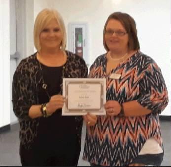 Clarence B. Wright/The                                Newcastle Pacer                                Chamber President/ CEO Presiident presents Robin Reed with a certificate honoring her as Volunteer of the Month for September.